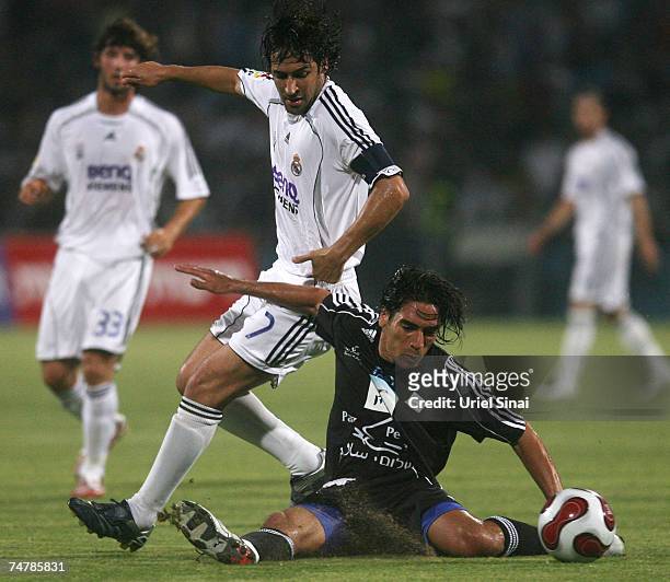 Raul Gonzalez of Real Madrid is tackled by Yoav Ziv of the Peace Team during the match between Real Madrid and a Palestinian & Israeli XI at the...