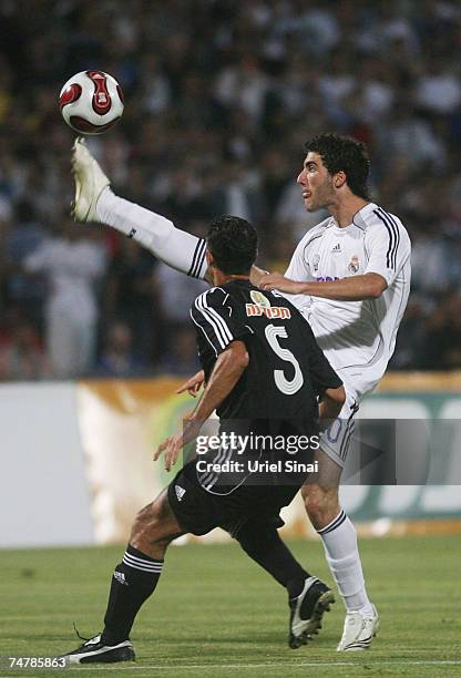 Gonzalo Gerardo of Real Madrid tackles Alon Harazi of the Peace Team during the match between Real Madrid and a Palestinian & Israeli XI at the Ramat...