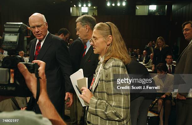 Senate Judiciary Chairman Patrick J. Leahy, D-Vt., and Sen. Charles E. Grassley, R-Iowa, escort witness Coleen Rowley, an FBI special agent in...