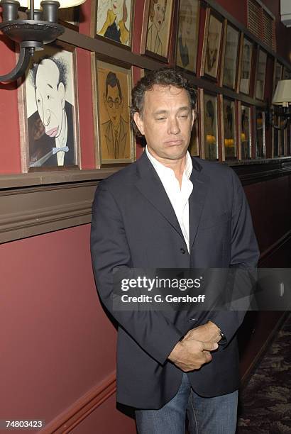 Tom Hanks with a caricature of Menasha Skulnick at the Sardi's Restaurant in New York City, New York
