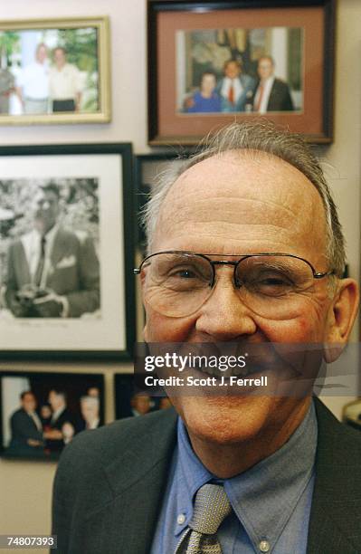 Behind Cass Ballenger, R-N.C., is a wall of photos in his office in Rayburn of his visits over the years with past and present presidents of...