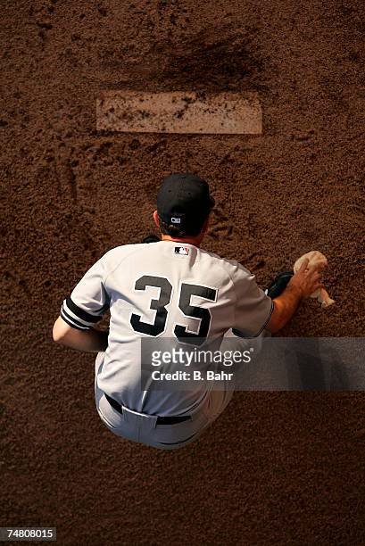 Starting pitcher Mike Mussina of the New York Yankees grabs the chalk bag before warming up in the bullpen before a game against the Colorado Rockies...
