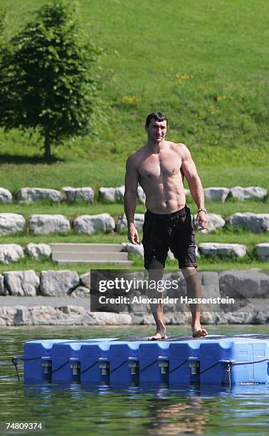 And IBO World Heavyweight Champion Wladimir Klitschko of Ukraine enjoys a morning swim at the Going Bergsee in front of the Tyrolian Mountains...