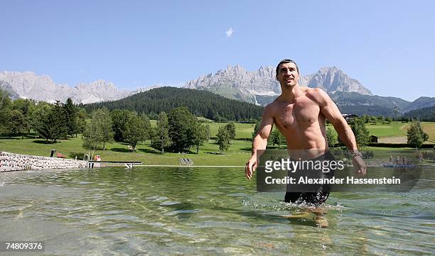 And IBO World Heavyweight Champion Wladimir Klitschko of Ukraine enjoys a morning swim at the Going Bergsee in front of the Tyrolian Mountains...