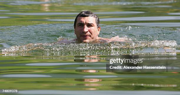 And IBO World Heavyweight Champion Wladimir Klitschko of Ukraine enjoys a morning swim at the Going Bergsee in front of the Tyrolian Mountains...