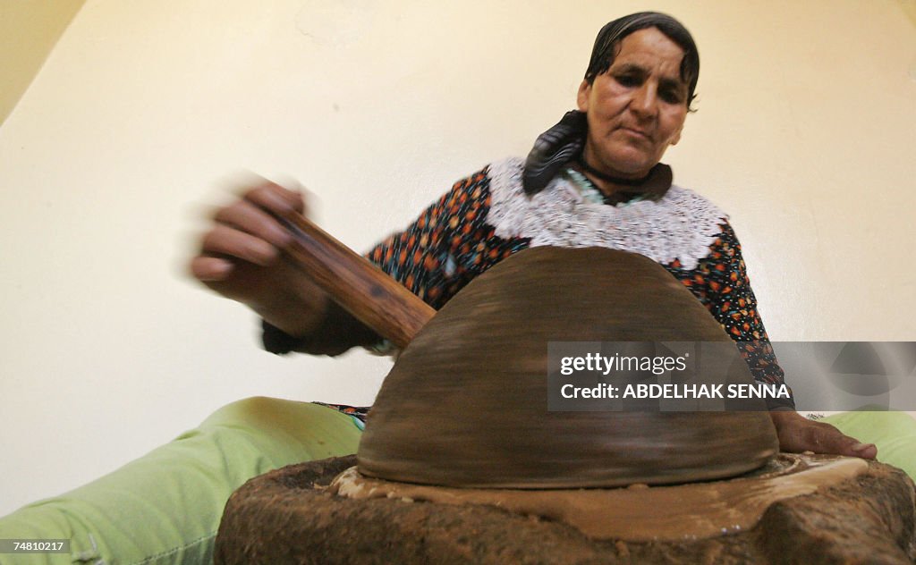 A Moroccan woman crushes Argan tree (Arg...