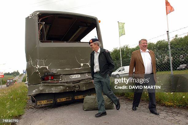 Resigning Belgian Defense Minister Andre Flahaut inspects one of four military buses damaged 20 June 2007 after colliding while travelling in a...