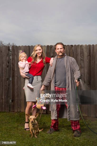 caucasian couple posing near wooden fence with baby daughter - robe 2017 stock pictures, royalty-free photos & images