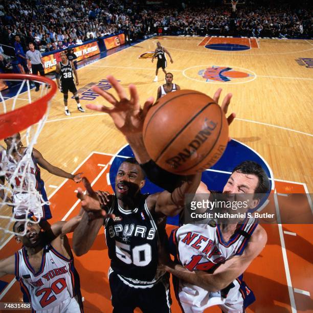 David Robinson of the San Antonio Spurs shoots against Chris Dudley of the New York Knicks during Game Five of the 1999 NBA Finals at Madison Square...