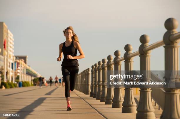 caucasian teenage girl running on boardwalk - virginia beach va stock pictures, royalty-free photos & images