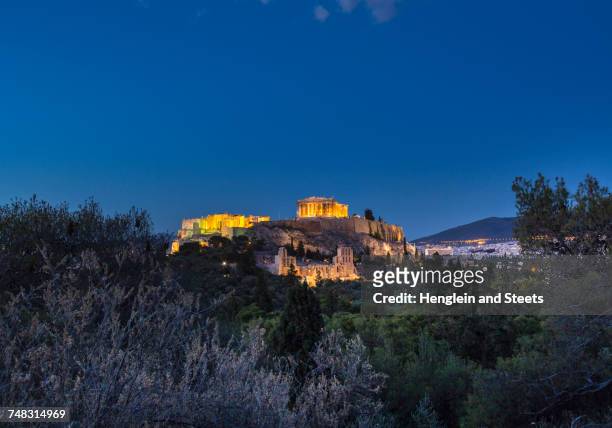 the acropolis illuminated at night, athens, attiki, greece, europe - acropolis athens stock pictures, royalty-free photos & images