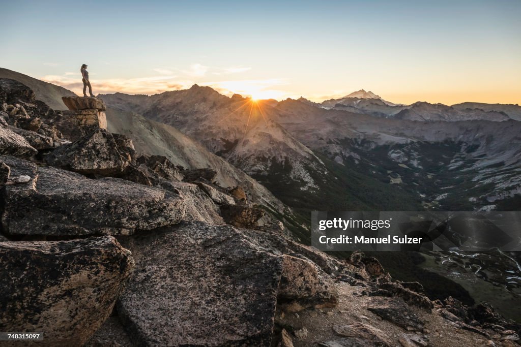 Female mountaineer looking out over Andes mountain range, Nahuel Huapi National Park, Rio Negro, Argentina