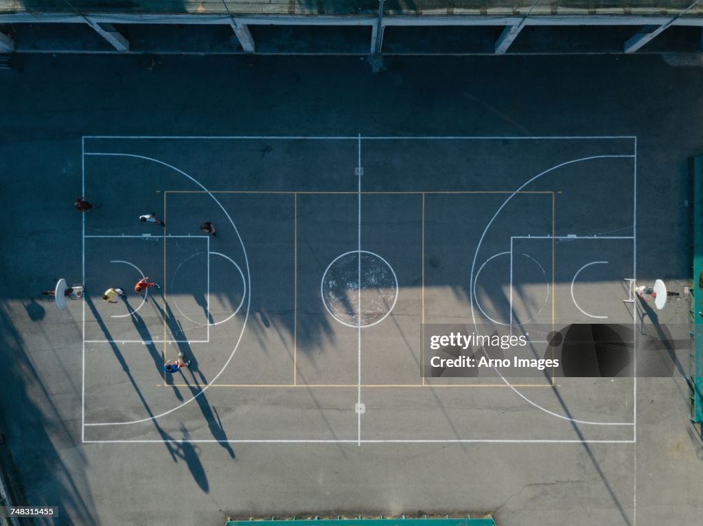 Overhead view of friends on basketball court playing basketball game