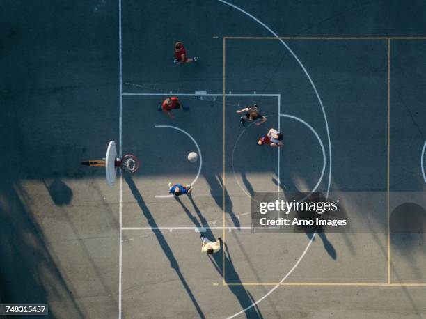 overhead view of friends on basketball court playing basketball game - teamsport stockfoto's en -beelden