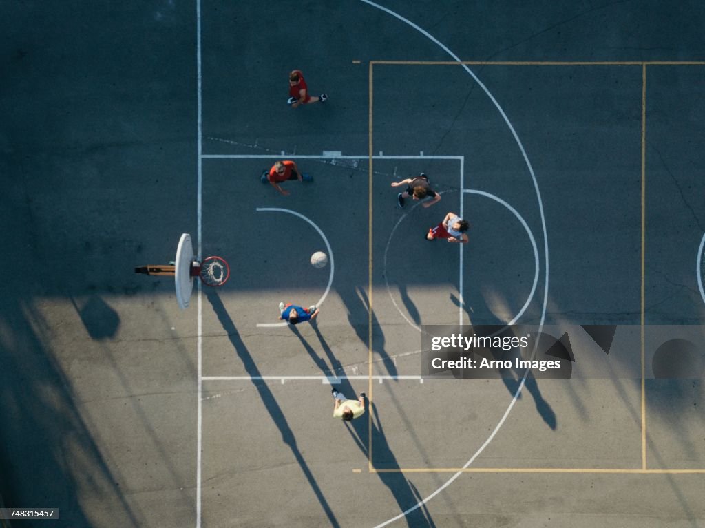 Overhead view of friends on basketball court playing basketball game