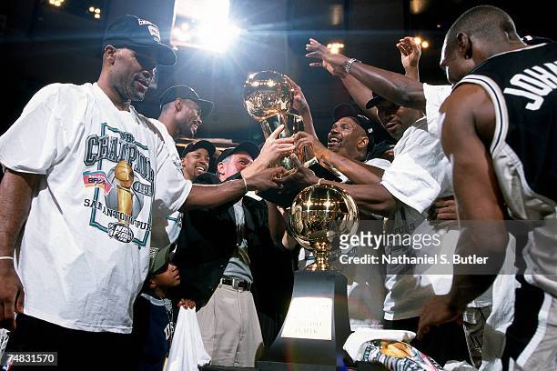 The San Antonio Spurs celebrate with the Larry O'Brien trophy following Game Five of the 1999 NBA Finals at Madison Square Garden on June 25, 1999 in...