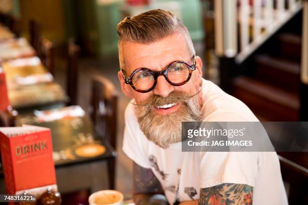 quirky man in bar and restaurant, bournemouth, england - barba peluria del viso foto e immagini stock