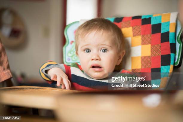 frustrated mixed race baby boy sitting in high chair - tensed idaho stock pictures, royalty-free photos & images