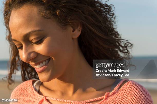 portrait of smiling african american woman at beach - african american women in the wind stock pictures, royalty-free photos & images