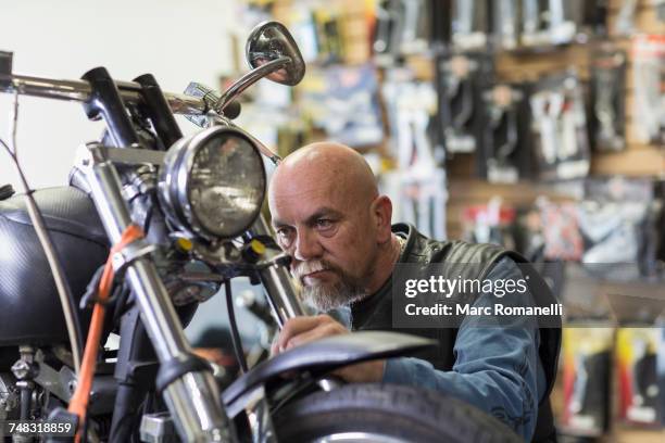 caucasian man repairing motorcycle - old motorcycles imagens e fotografias de stock