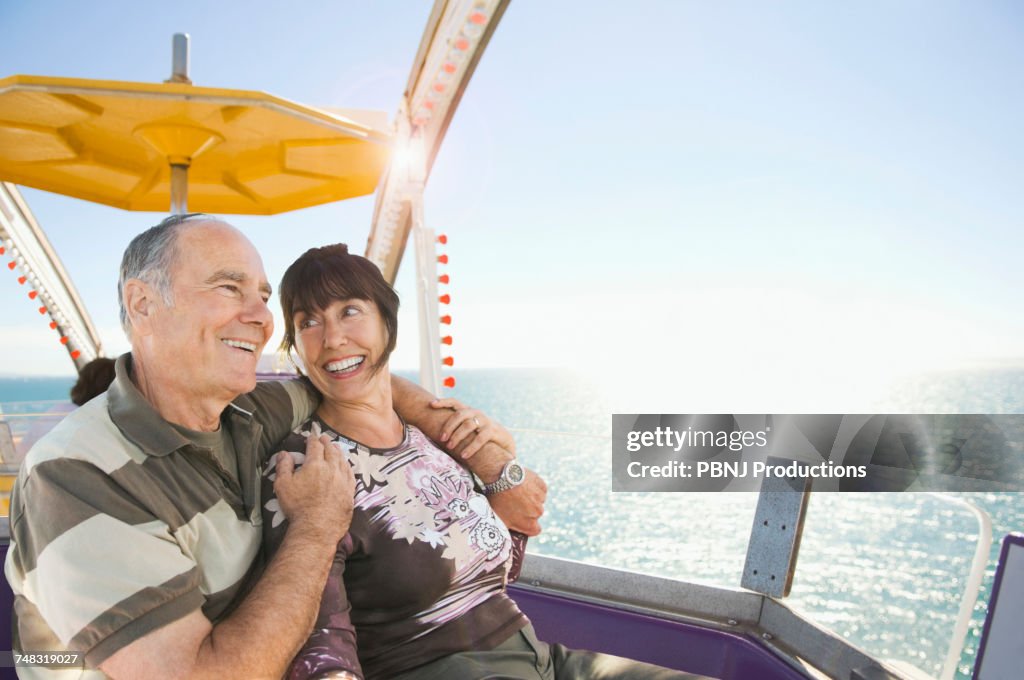 Senior couple sitting near ocean