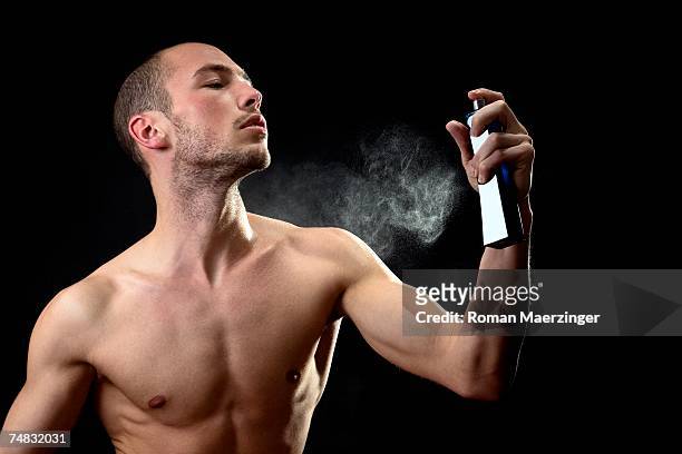 man spraying fragrance - perfume sprayer stock pictures, royalty-free photos & images