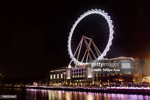 illuminated ferris wheel at night, zhongshan, guangdong, china - zhongshan stock pictures, royalty-free photos & images