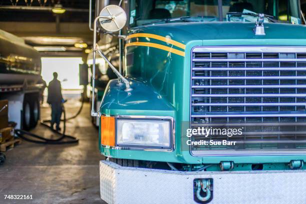 worker refuelling biofuel tankers in biofuel plant depot - fuel efficiency stock pictures, royalty-free photos & images