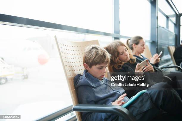 family at airport on way to holiday, copenhagen, denmark - child waiting stock pictures, royalty-free photos & images