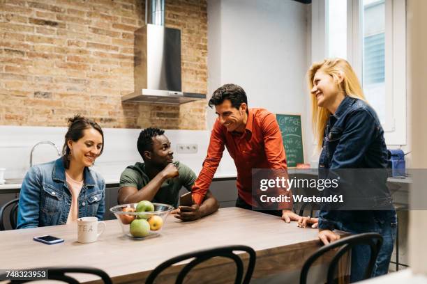 colleagues having a break in office kitchen - staffroom stock pictures, royalty-free photos & images