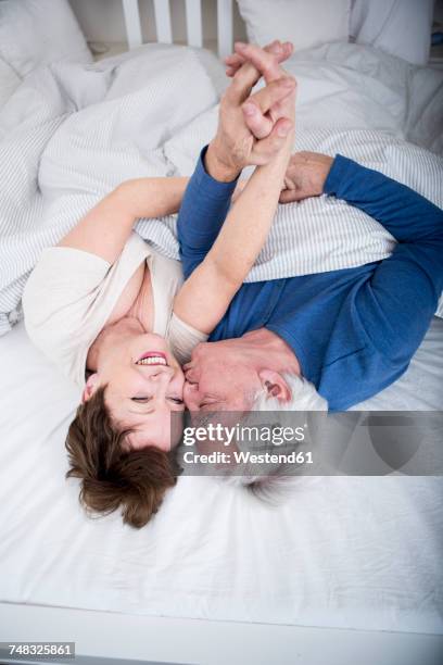senior couple having fun in bed - erotische stock-fotos und bilder