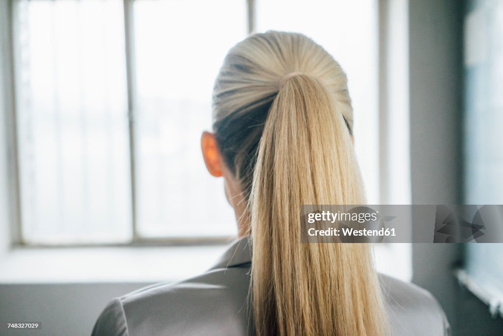 Back view of blond woman with ponytail