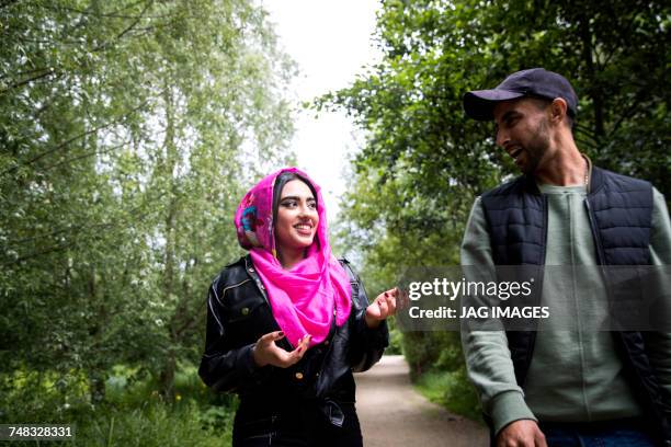 couple walking in park - couple walking in park stock pictures, royalty-free photos & images