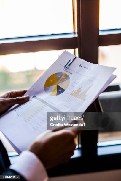 close-up of businesswoman holding document - budget 2017 stock-fotos und bilder