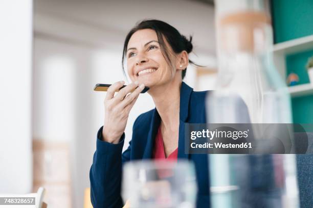 portrait of smiling businesswoman on the phone - diktera bildbanksfoton och bilder
