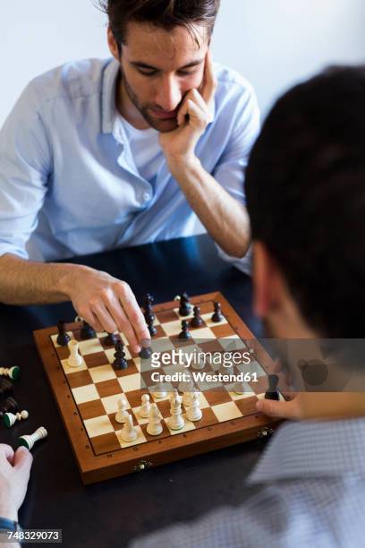 two men playing chess - chess board businessman stock-fotos und bilder