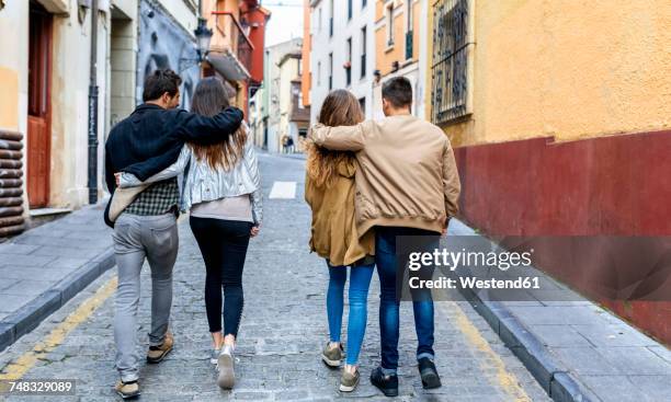 Two couples strolling in the city