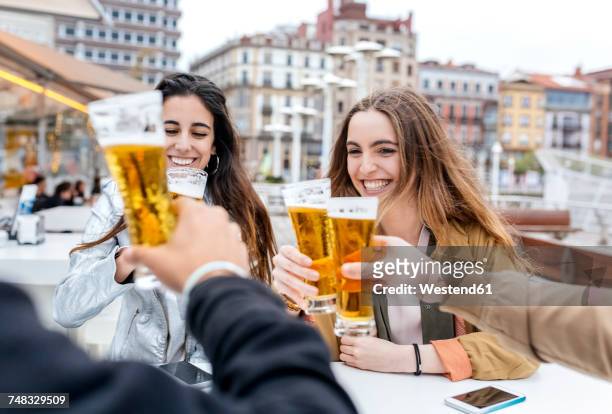 group of friends toasting with beer - gijon ストックフォトと画像