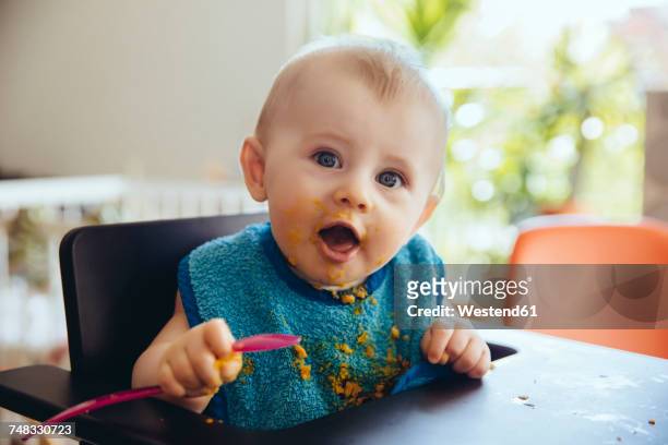 portrait of baby boy after having a meal - baby eating stock-fotos und bilder