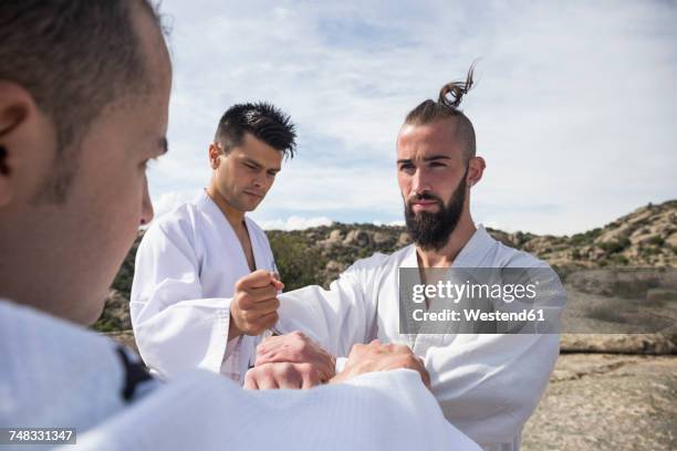men doing grip exercises during a martial arts training - strictness stock pictures, royalty-free photos & images
