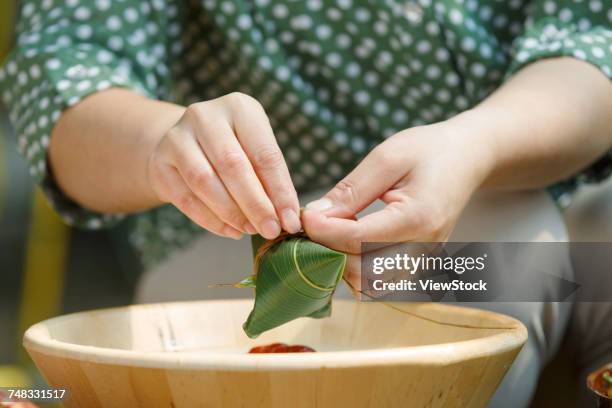 middle-aged women are making zongzi - kompetenz bündeln stock-fotos und bilder