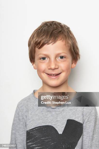 portrait of boy looking at camera smiling - boy white background stock-fotos und bilder