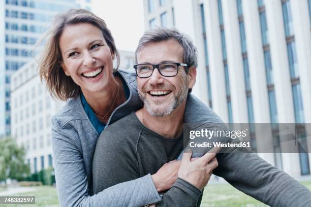 happy mature couple hugging outdoors - 40s couple stockfoto's en -beelden