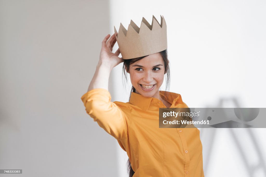 Happy young woman with crown on her head