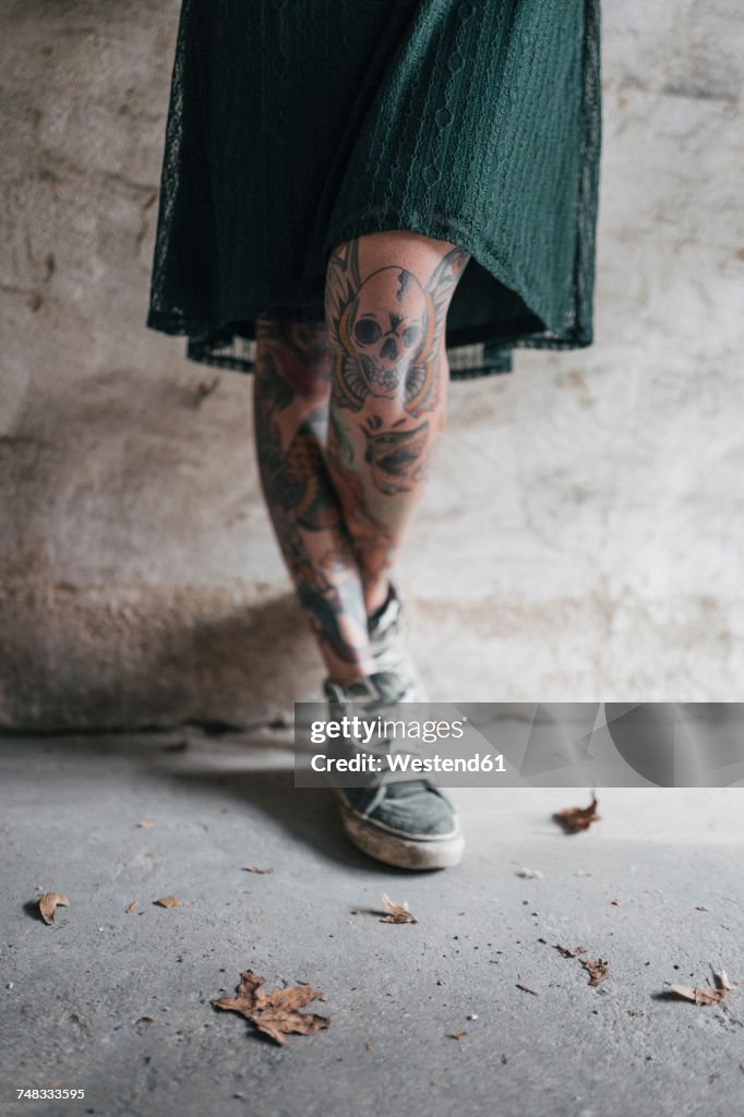 Legs of a young woman with tattoos