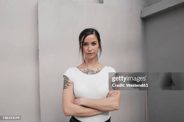 portrait of a young woman with tattoos - oproer stockfoto's en -beelden