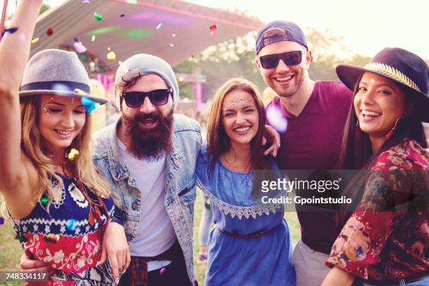 portrait of young adult friends having fun at festival - coat music festival stock pictures, royalty-free photos & images
