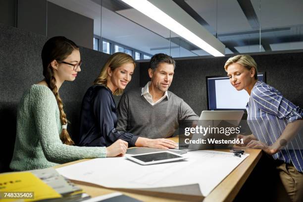 colleagues with laptop having a meeting in meeting box - girls germany team presentation stock pictures, royalty-free photos & images