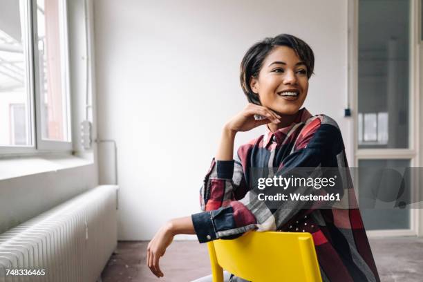 smiling woman sitting on chair - sitting chair office relax stock pictures, royalty-free photos & images