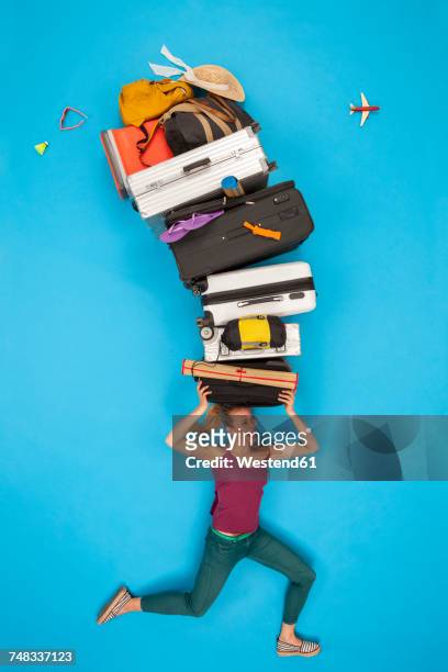 woman balancing luggage on her head - suitcase from above stock pictures, royalty-free photos & images